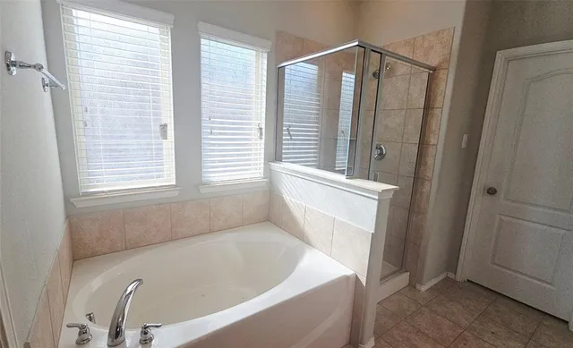 a bath tub sitting in a bathroom next to a window