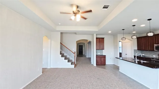 a view of living room with furniture and a ceiling fan