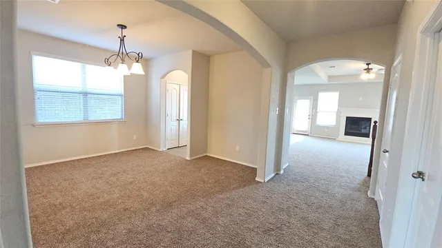 en view interior of a house with a windows and a chandelier