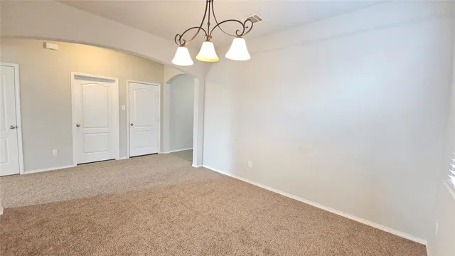 a view of a chandelier fan and closet in a room