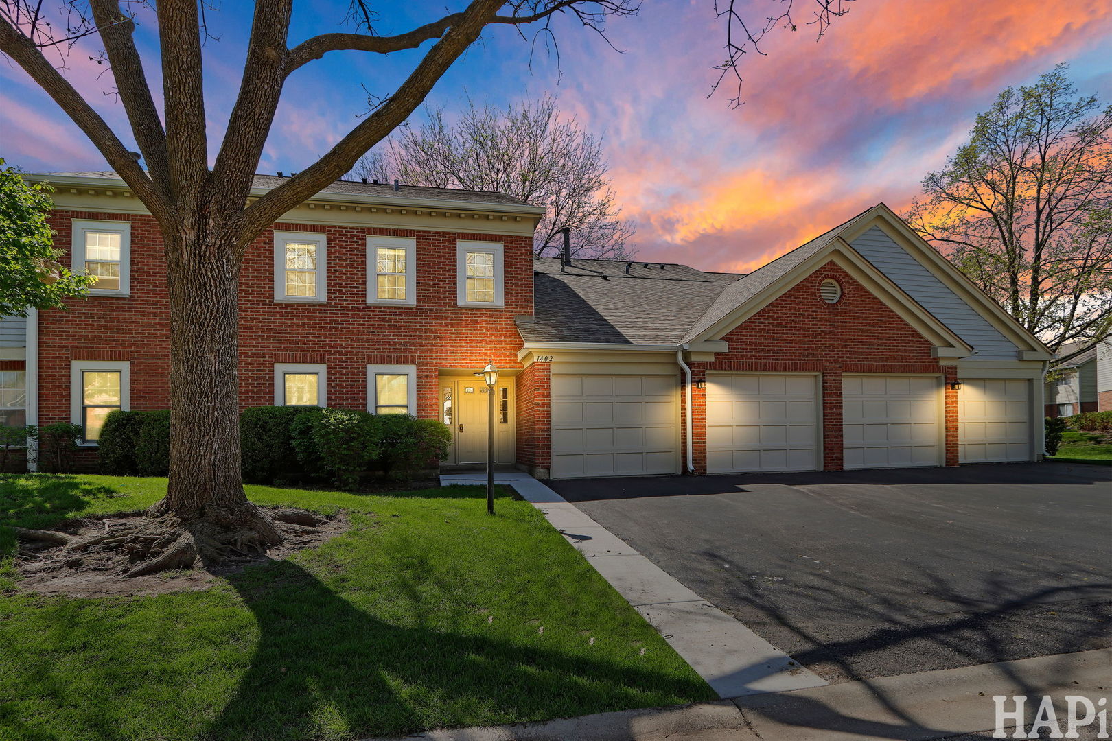 1402 Aldgate Court, Unit D1 Wheeling, IL 60090 - Photo 1 of 25 a front view of a house with a yard and garage