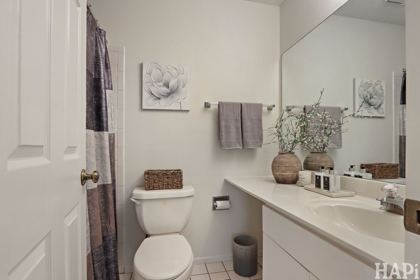 1402 Aldgate Court, Unit D1 Wheeling, IL 60090 - Photo 13 of 25 a bathroom with a toilet sink and mirror