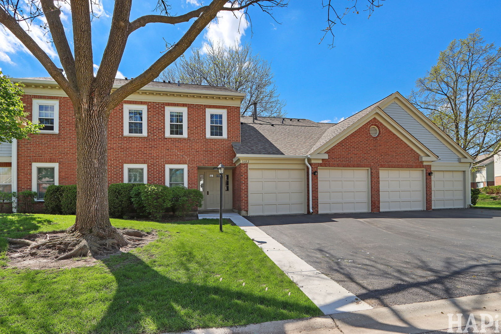 1402 Aldgate Court, Unit D1 Wheeling, IL 60090 - Photo 2 of 25 a front view of a house with a yard and garage