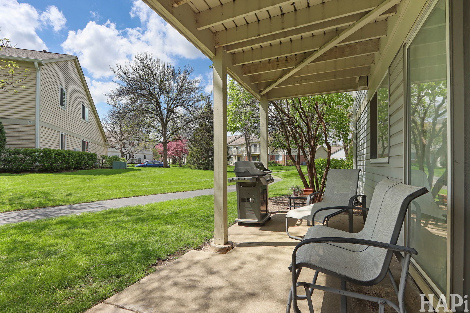 1402 Aldgate Court, Unit D1 Wheeling, IL 60090 - Photo 23 of 25 a view of a chair and table in backyard of the house