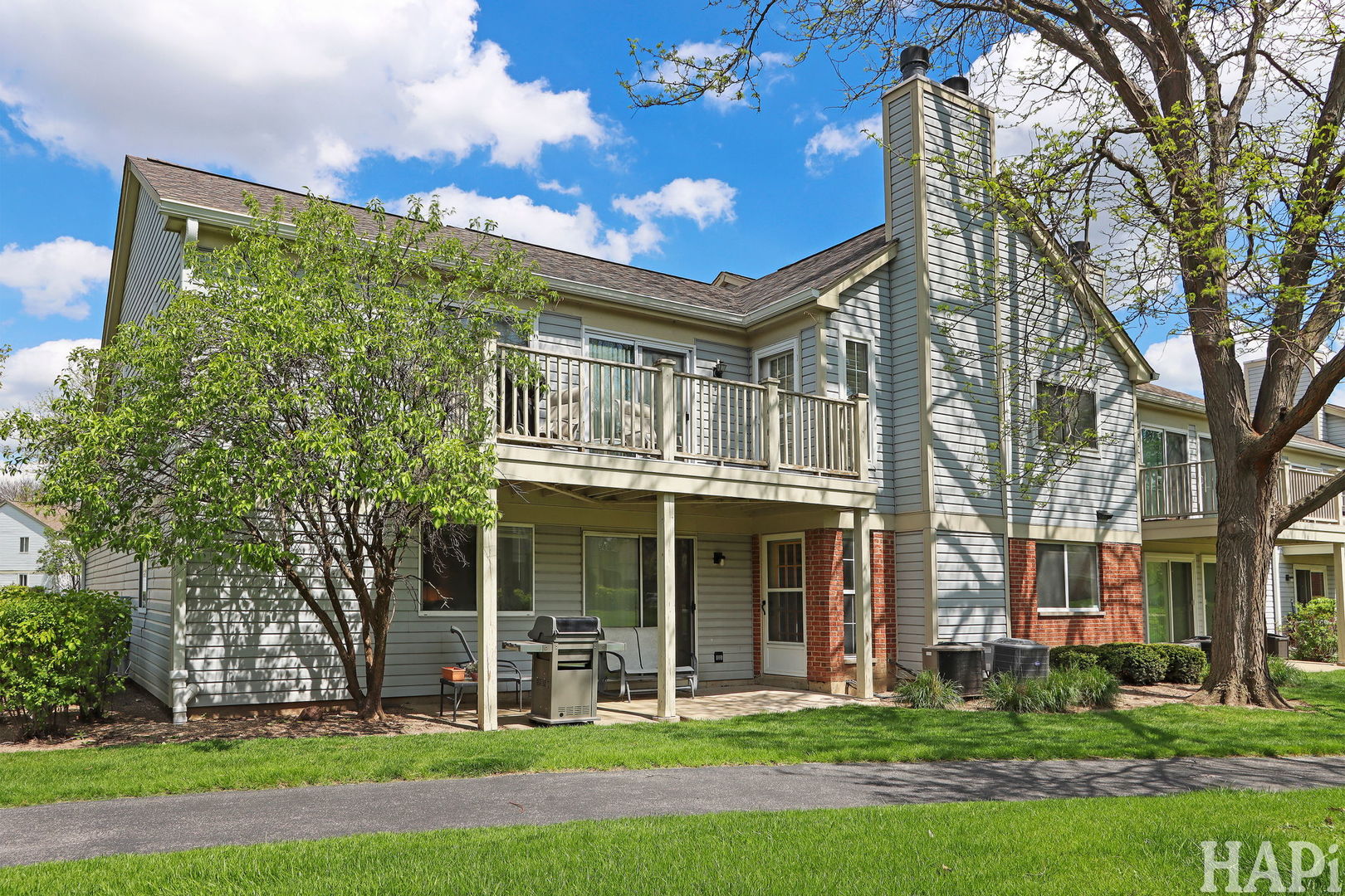 1402 Aldgate Court, Unit D1 Wheeling, IL 60090 - Photo 24 of 25 front view of a brick building with a yard