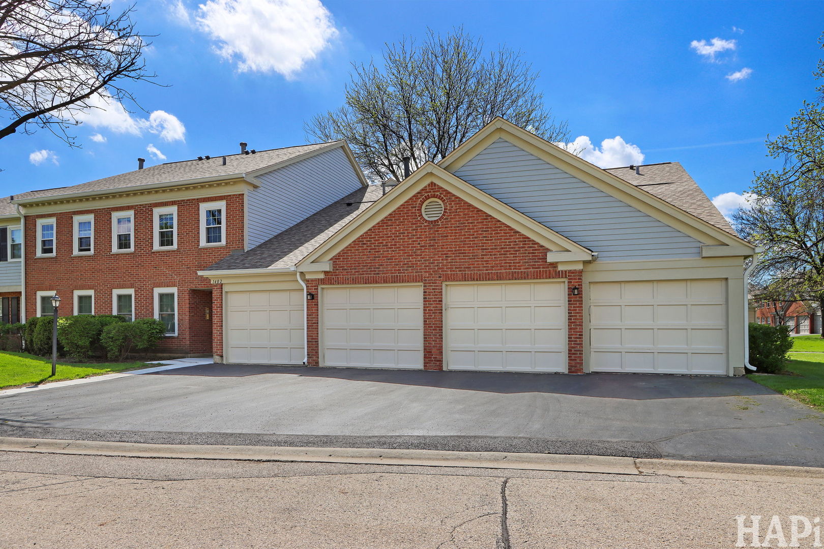 1402 Aldgate Court, Unit D1 Wheeling, IL 60090 - Photo 3 of 25 a front view of a house with a yard and garage