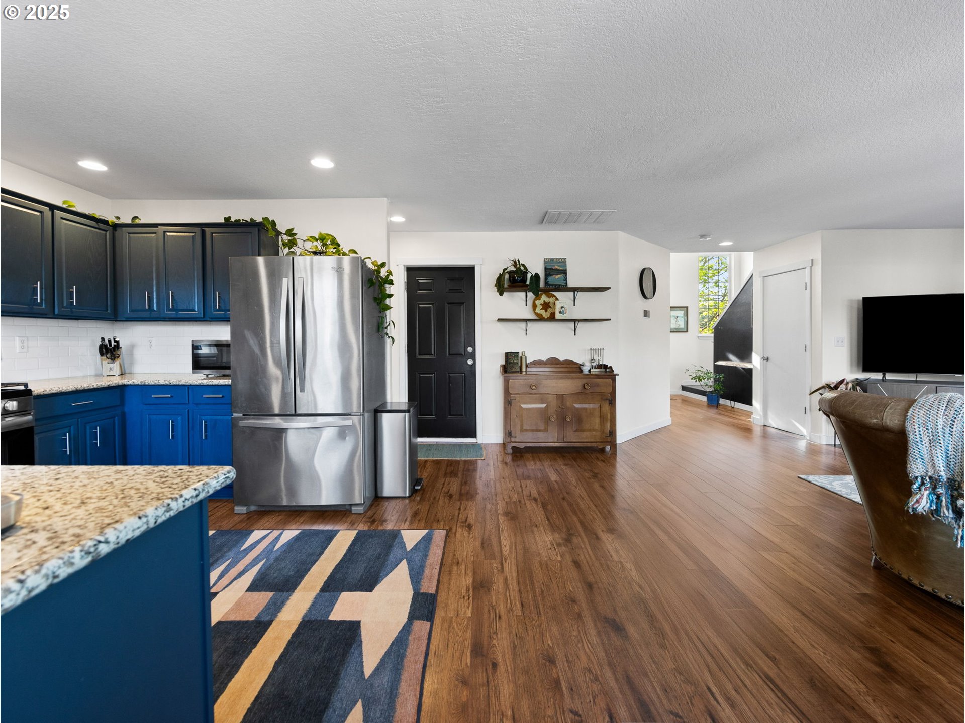 18254 Myra Court Sandy, OR 97055 - Photo 12 of 42 a kitchen with stainless steel appliances a refrigerator sink and wooden floor