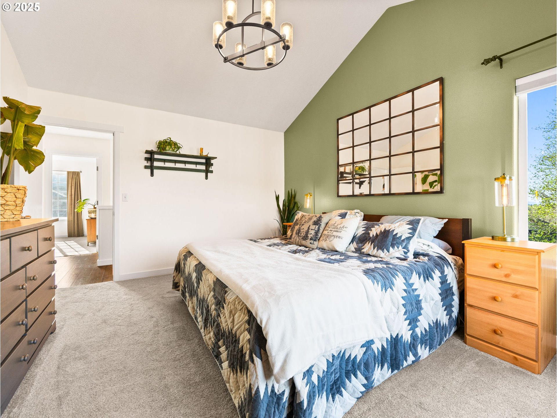 18254 Myra Court Sandy, OR 97055 - Photo 16 of 42 a bedroom with a bed and a chandelier