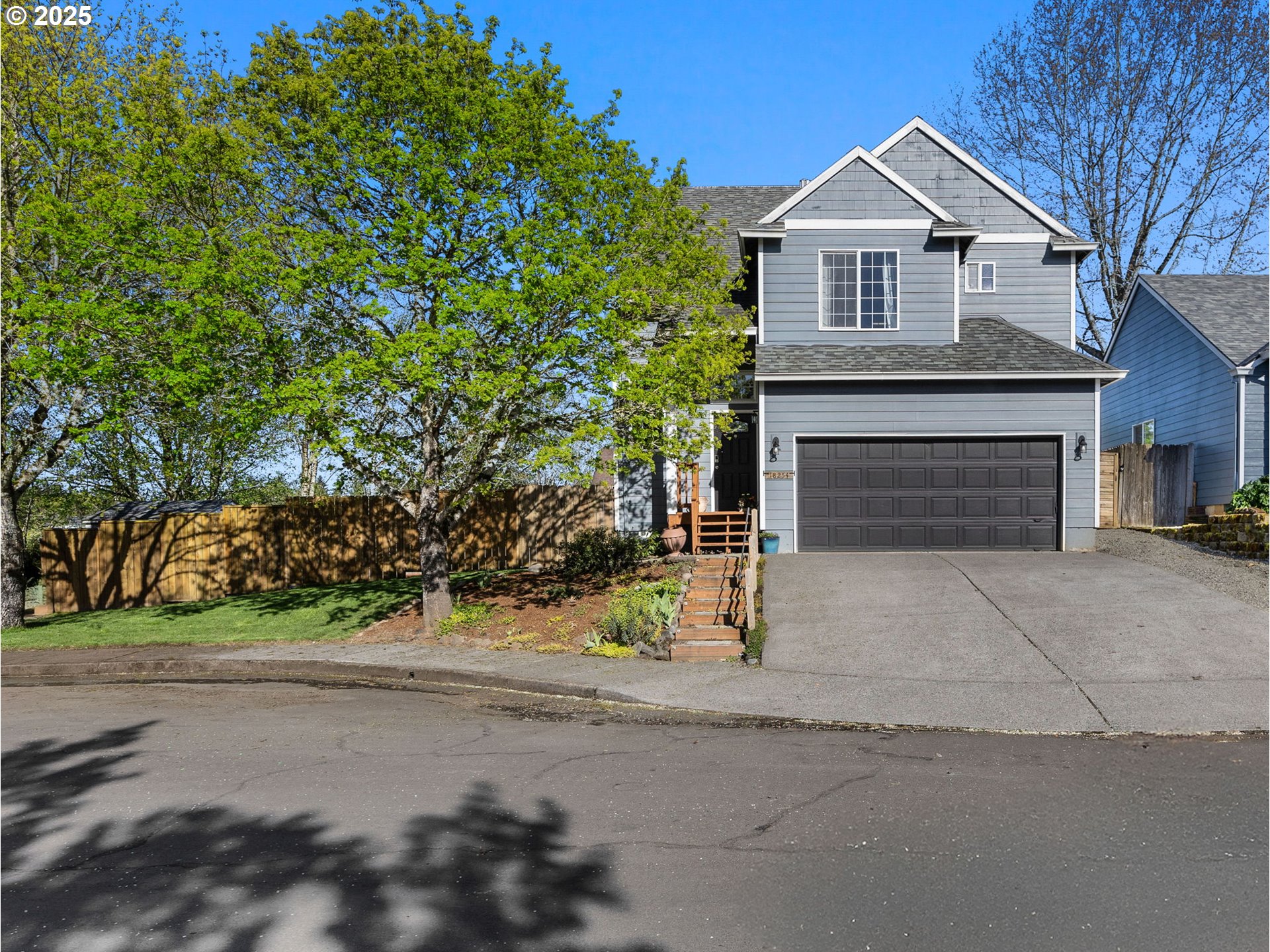 18254 Myra Court Sandy, OR 97055 - Photo 2 of 42 a front view of a house with a yard and garage