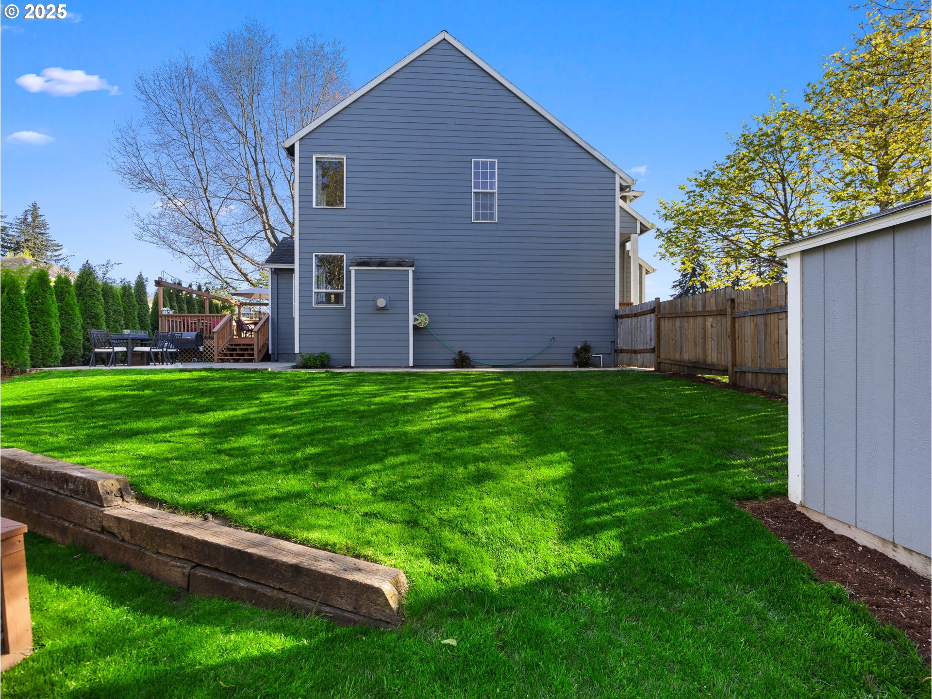 18254 Myra Court Sandy, OR 97055 - Photo 38 of 42 a backyard of a house with plants and large tree