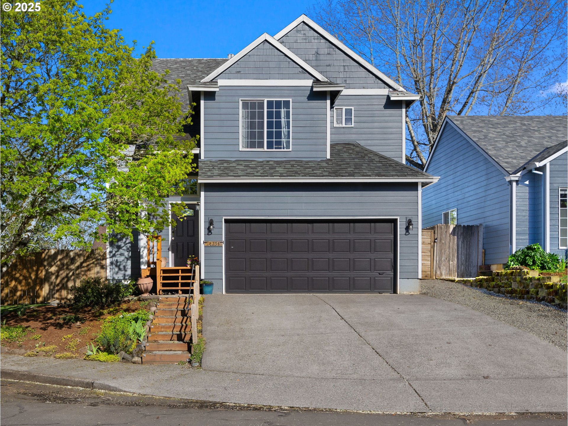 18254 Myra Court Sandy, OR 97055 - Photo 42 of 42 a front view of a house with a yard and garage