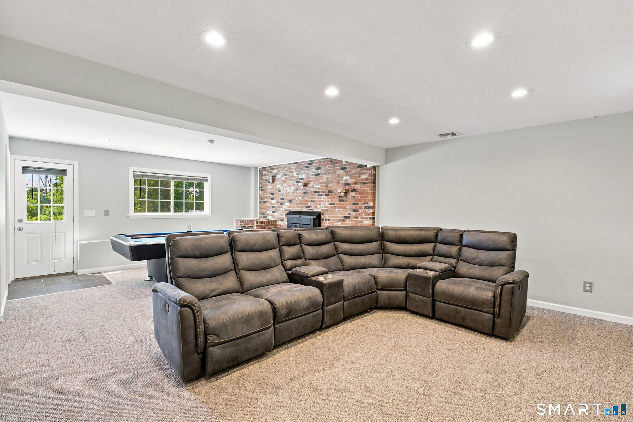 400 Old Day Hill Road Windsor, CT 06095 - Photo 32 of 35 Recreation area with entertainment sofa. Lower level walk out basement with fireplace