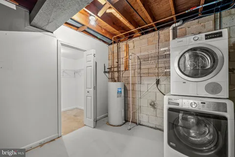 a view of a storage & utility room with a washer dryer