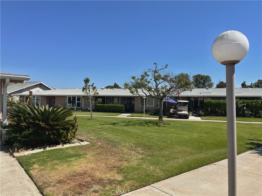 1075 Brookline Road Seal Beach, CA 90740 - Photo 5 of 13 a front view of a house with a yard table and chairs
