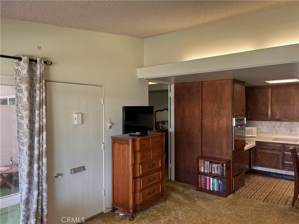 1075 Brookline Road Seal Beach, CA 90740 - Photo 7 of 13 a view of a kitchen with cabinets and wooden floor