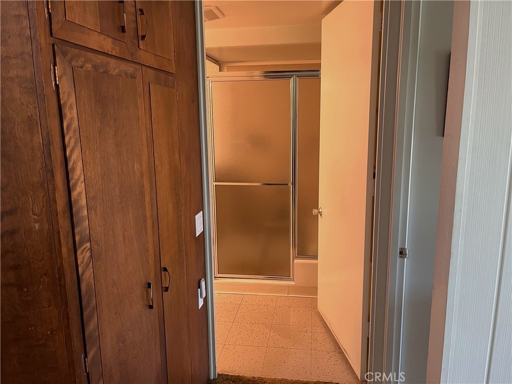 1075 Brookline Road Seal Beach, CA 90740 - Photo 9 of 13 a bathroom with a glass door shower