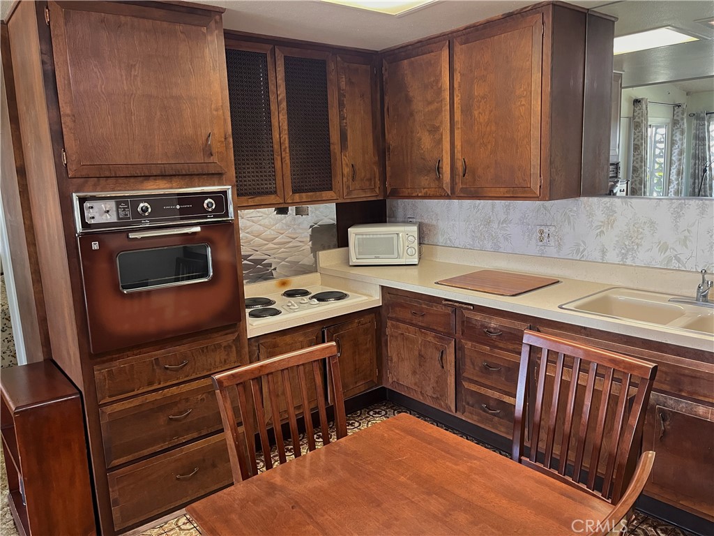 1075 Brookline Road Seal Beach, CA 90740 - Photo 10 of 13 a kitchen with a stove sink and cabinets