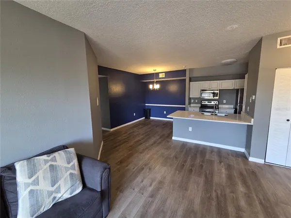 a view of a livingroom with furniture and a kitchen