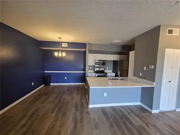 a view of a kitchen with a sink and a refrigerator