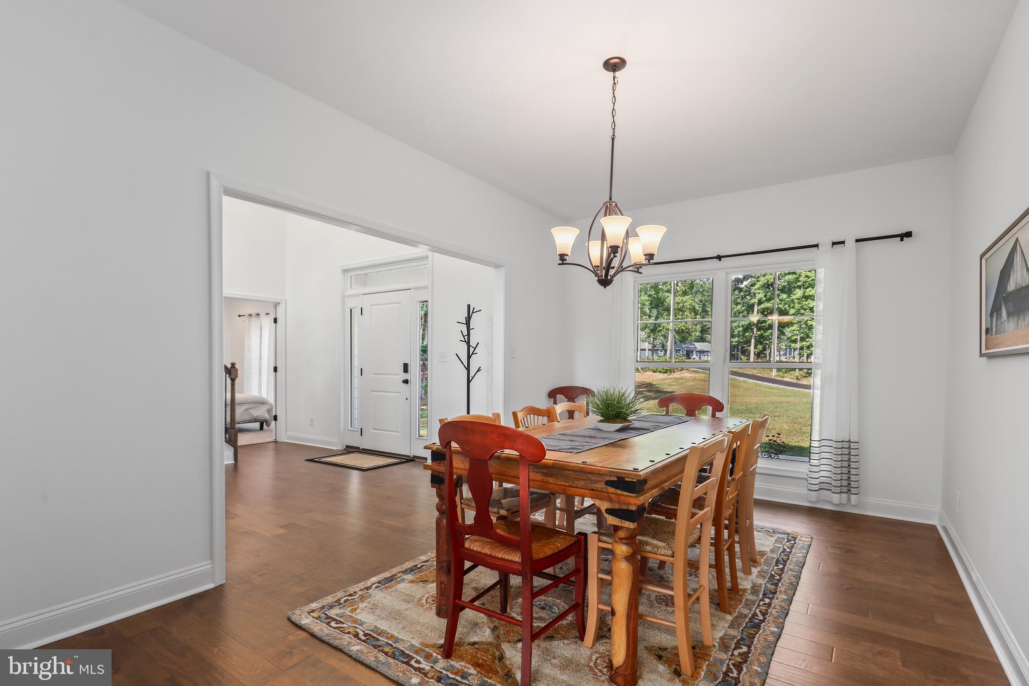 225 Raven Road Bumpass, VA 23024 - Photo 11 of 46 a view of a dining room with furniture window and wooden floor