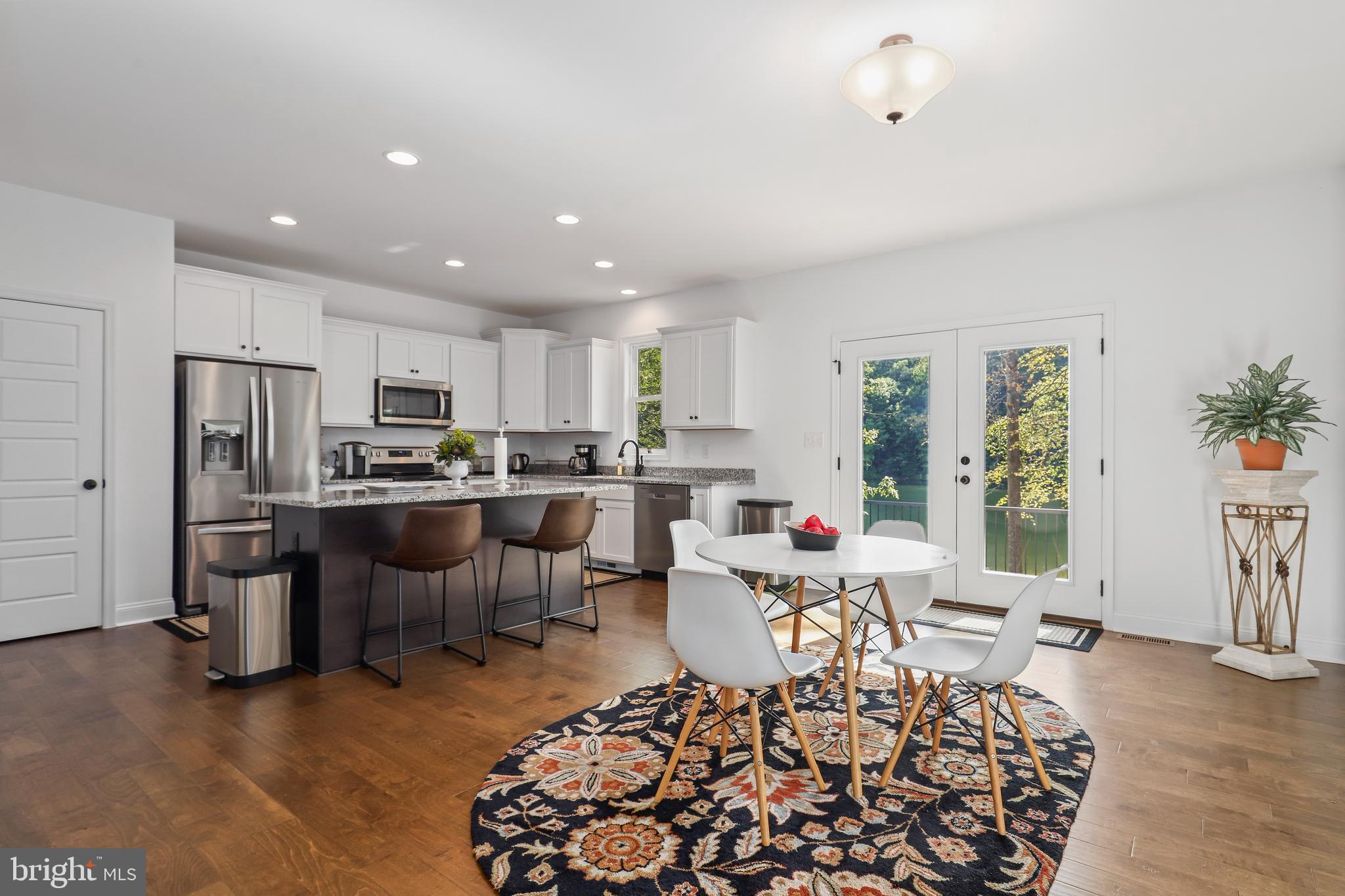 225 Raven Road Bumpass, VA 23024 - Photo 12 of 46 a living room with lots of furniture and kitchen view
