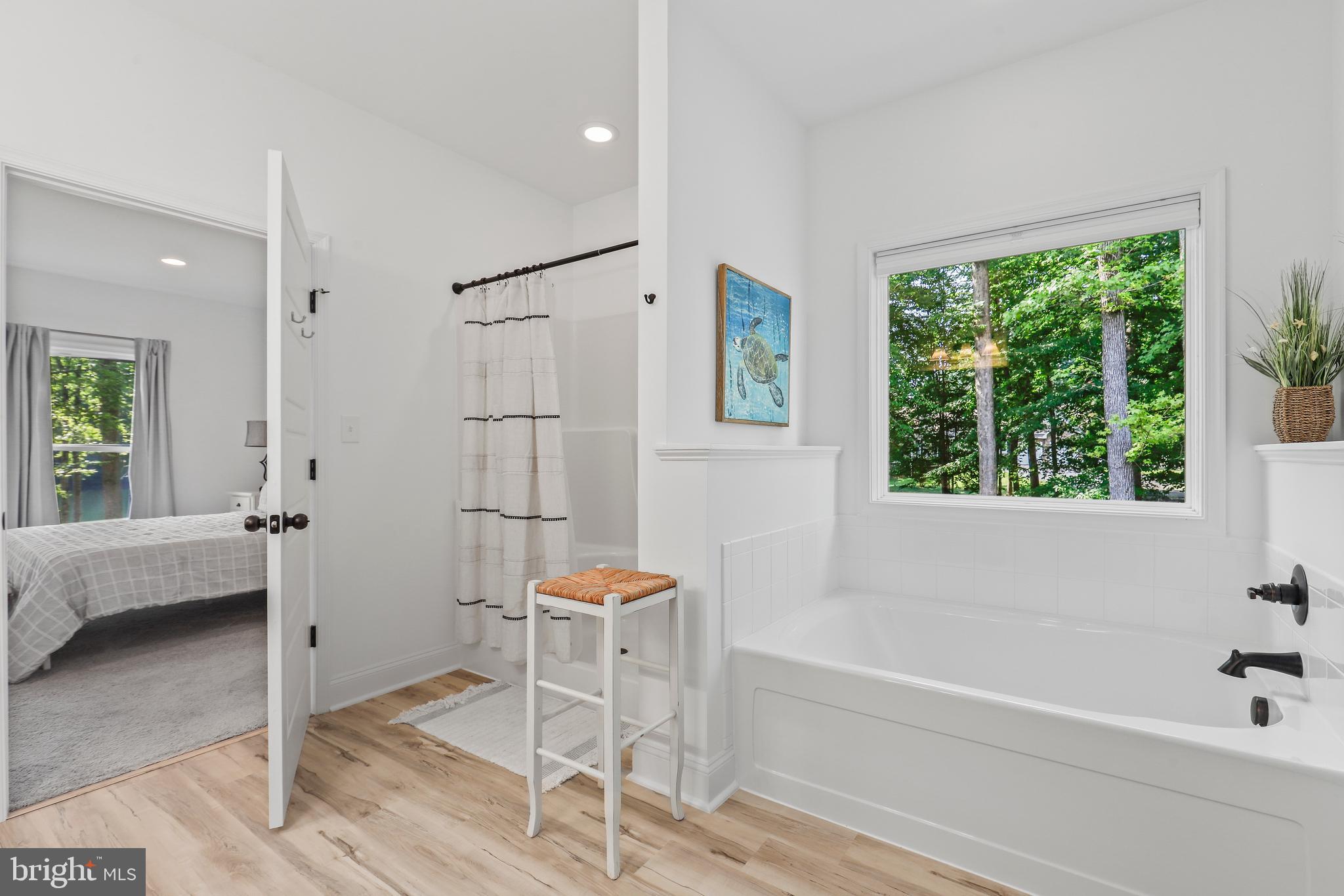 225 Raven Road Bumpass, VA 23024 - Photo 27 of 46 a bathroom with a bathtub and a shower