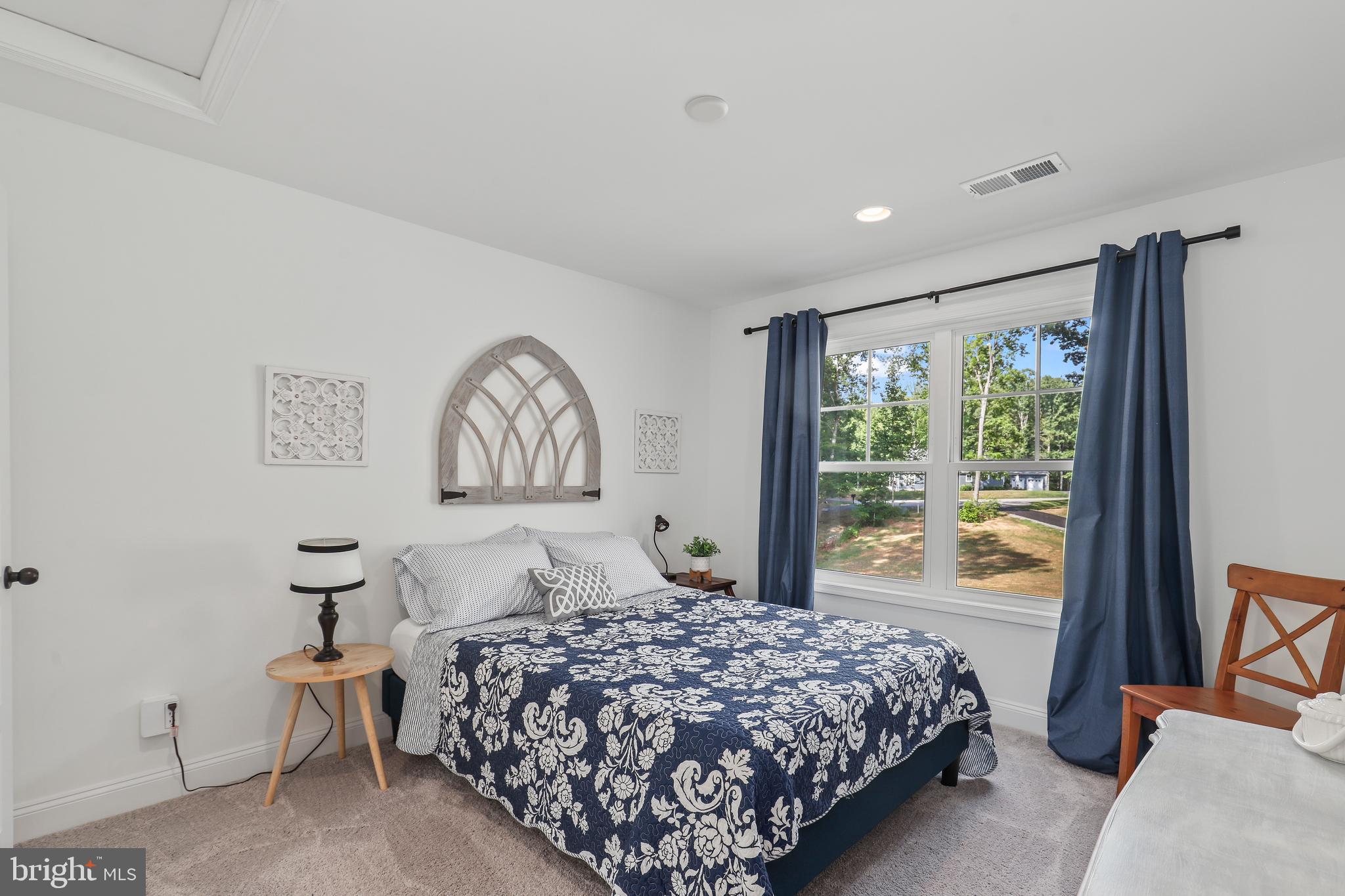 225 Raven Road Bumpass, VA 23024 - Photo 32 of 46 a bedroom with a large bed and a window