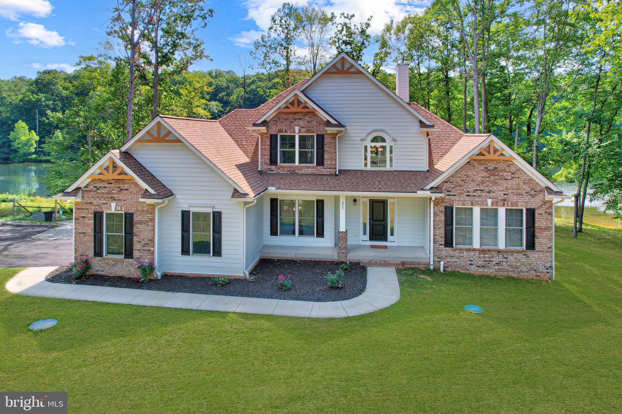225 Raven Road Bumpass, VA 23024 - Photo 38 of 46 a front view of house with a garden and patio