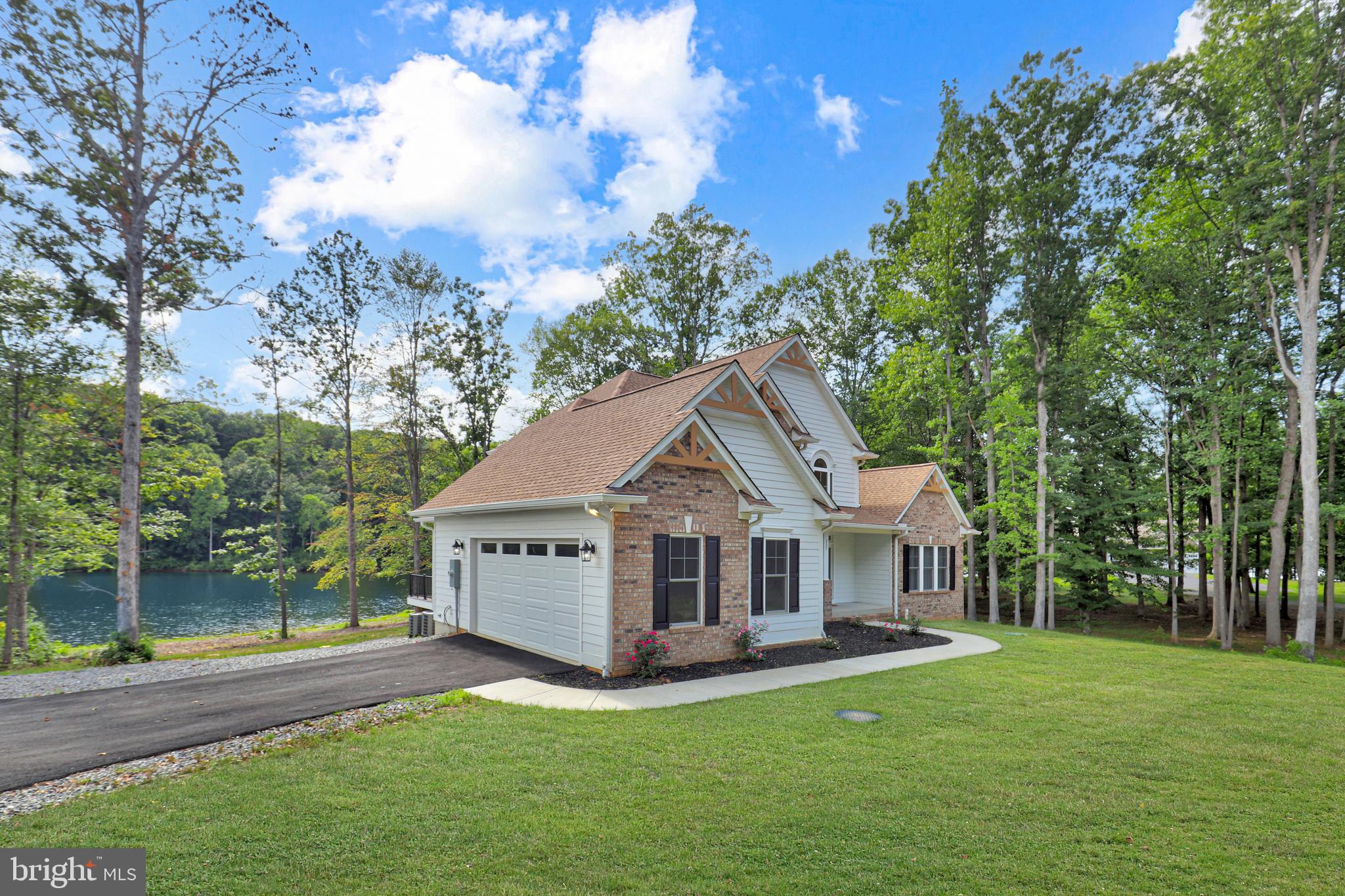 225 Raven Road Bumpass, VA 23024 - Photo 40 of 46 a front view of a house with yard and green space