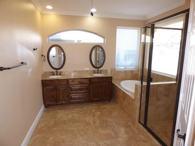 a bathroom with a toilet mirror vanity and a sink