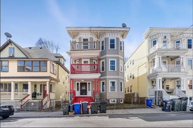 a kitchen with a refrigerator stove and wooden cabinets