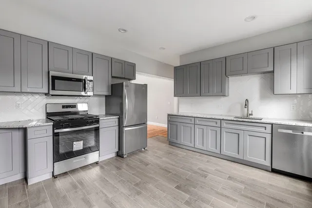 a view of a livingroom with wooden floor and window