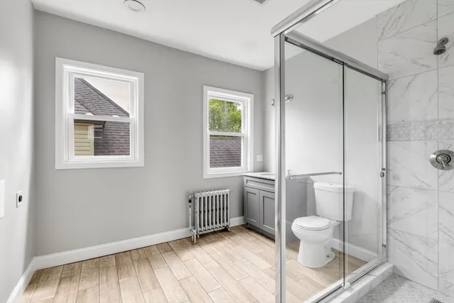 a bathroom with a toilet a sink and shower