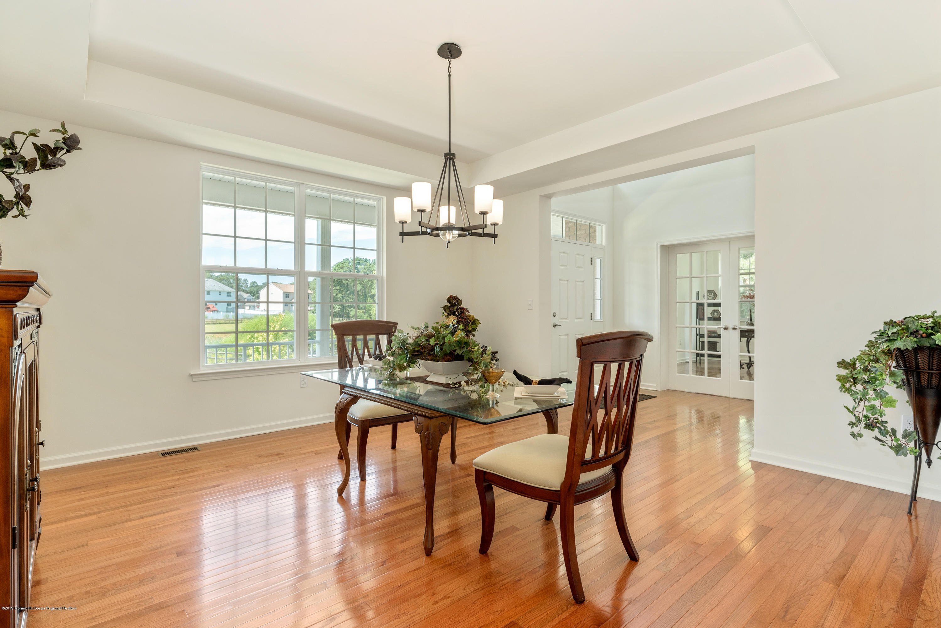 3 Bellagio Road Jackson, NJ 08527 - Photo 16 of 44 a dining room with furniture a chandelier and wooden floor