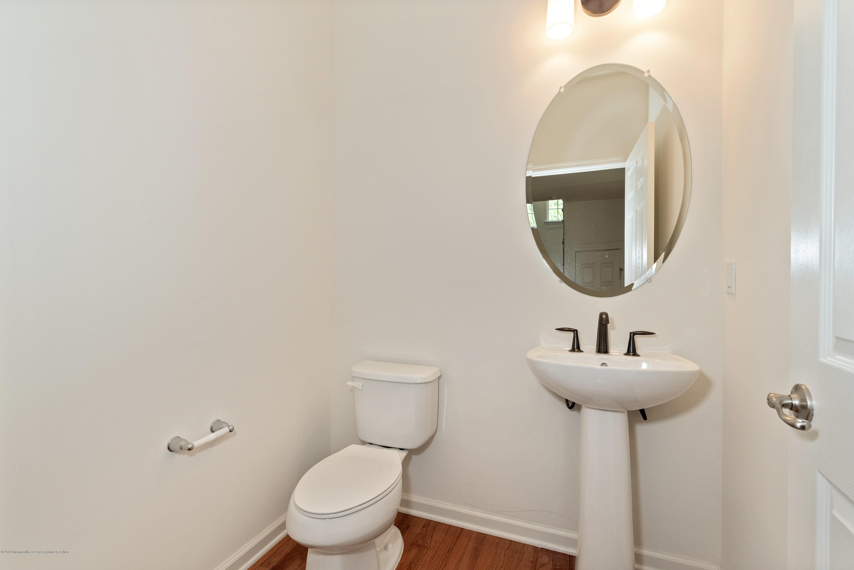3 Bellagio Road Jackson, NJ 08527 - Photo 19 of 44 a bathroom with a toilet sink and mirror