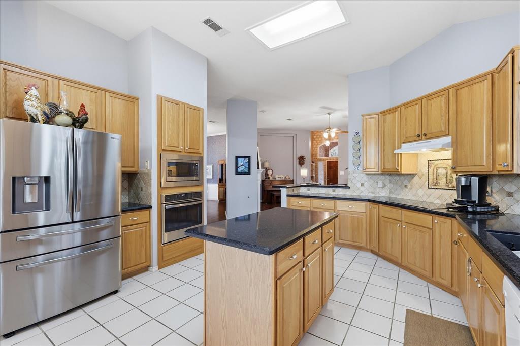 8409 Sequoia Way Fort Worth, TX 76137 - Photo 14 of 40 a kitchen with stainless steel appliances granite countertop a refrigerator a stove a sink and a refrigerator