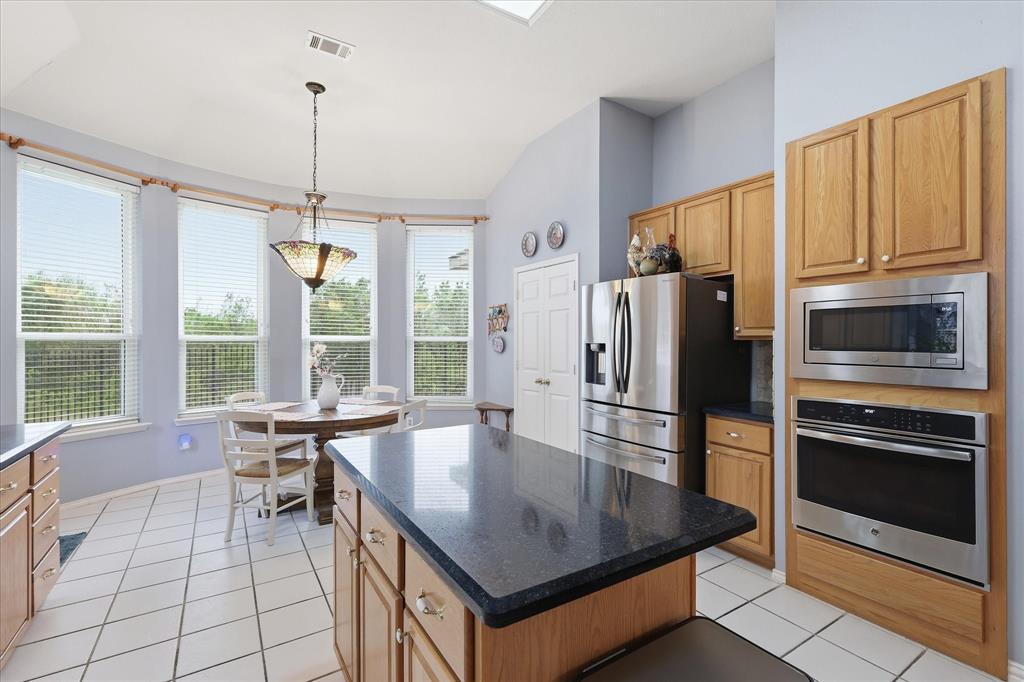 8409 Sequoia Way Fort Worth, TX 76137 - Photo 15 of 40 a kitchen with kitchen island a counter top space appliances and cabinets