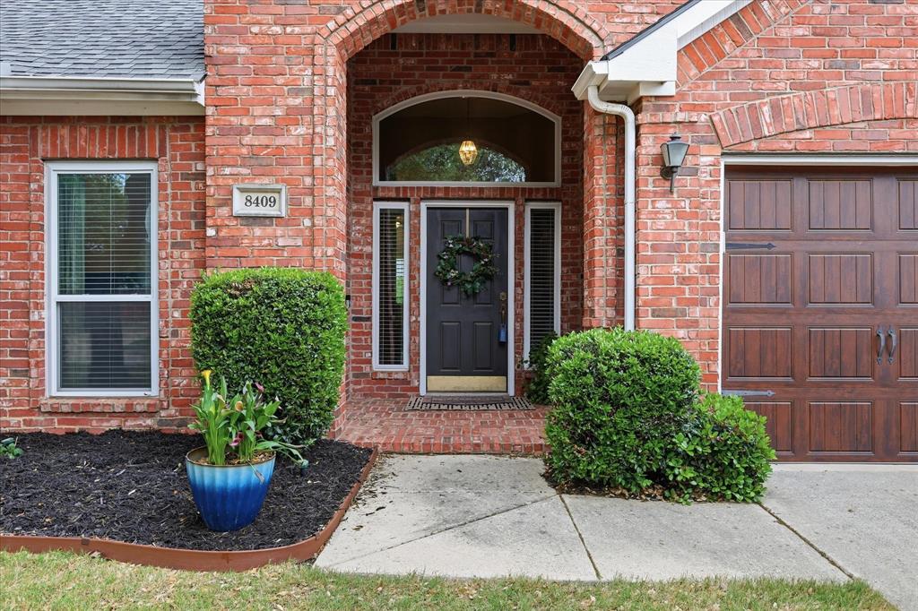8409 Sequoia Way Fort Worth, TX 76137 - Photo 2 of 40 a front view of a house with a garden