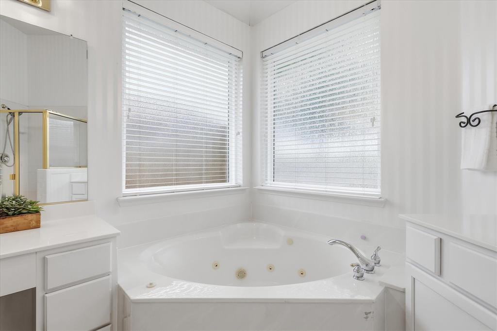 8409 Sequoia Way Fort Worth, TX 76137 - Photo 25 of 40 a white bath tub sitting next to a window