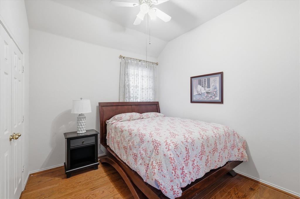 8409 Sequoia Way Fort Worth, TX 76137 - Photo 27 of 40 a bedroom with a bed and a chandelier