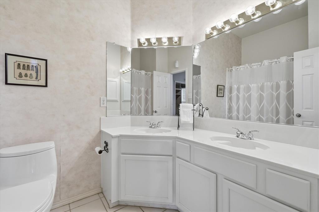8409 Sequoia Way Fort Worth, TX 76137 - Photo 30 of 40 a bathroom with a double vanity sink mirror and toilet