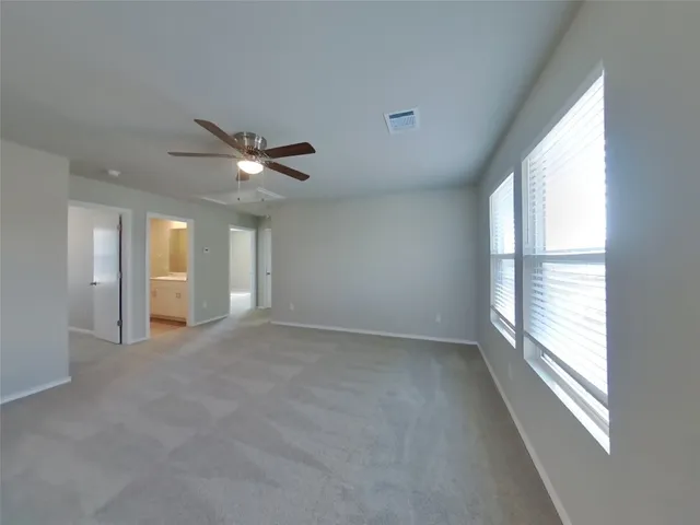 a view of an empty room with a kitchen