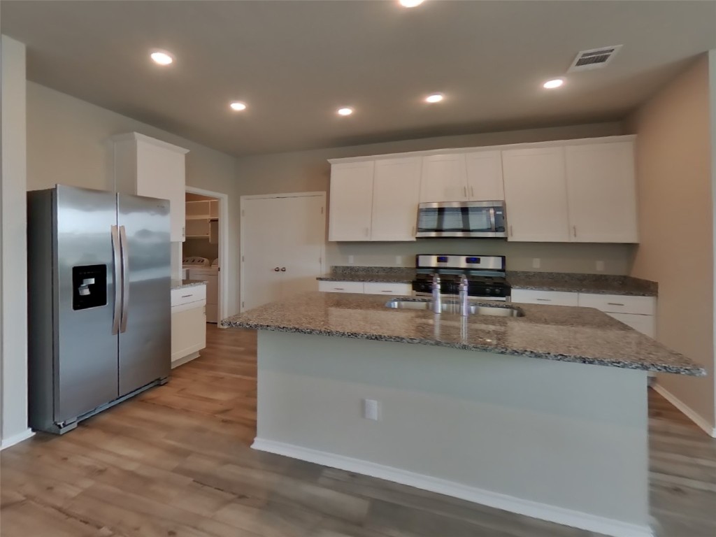 3600 Catlett Crk Road Georgetown, TX 78626 - Photo 4 of 28 a kitchen with stainless steel appliances granite countertop a stove a sink and a refrigerator