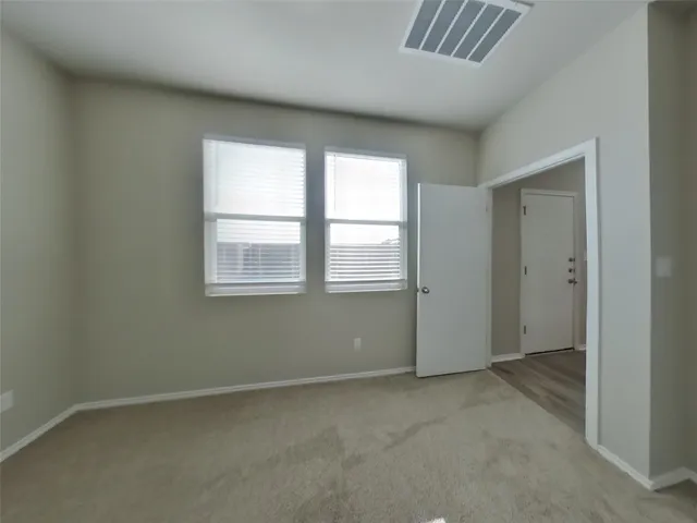 an empty room with closet area