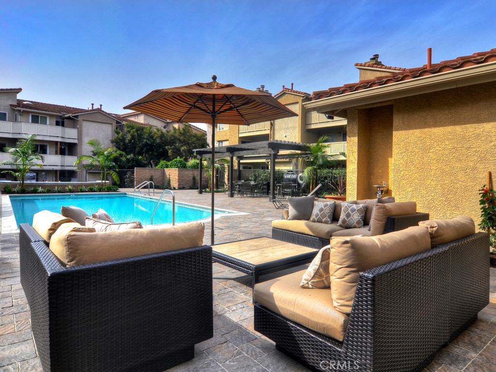 4 Corniche Drive, Unit B Dana Point, CA 92629 - Photo 26 of 41 a view of a patio with couches chairs and a umbrella