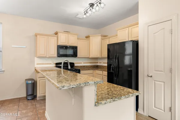 a kitchen with a refrigerator and a sink