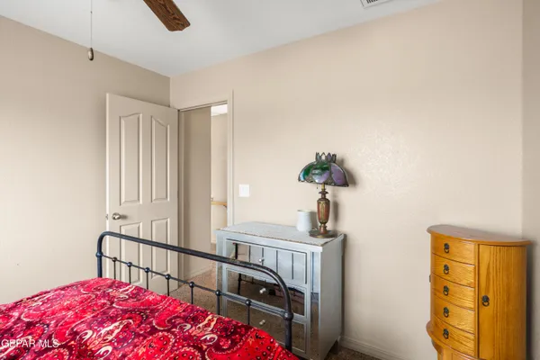 a bedroom with furniture and a window