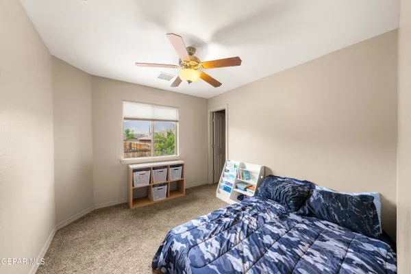 a bed room with a bed and a window