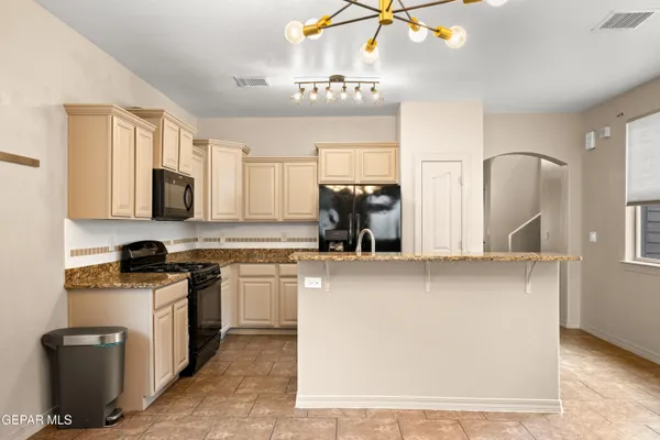 a kitchen with cabinets a window and stainless steel appliances