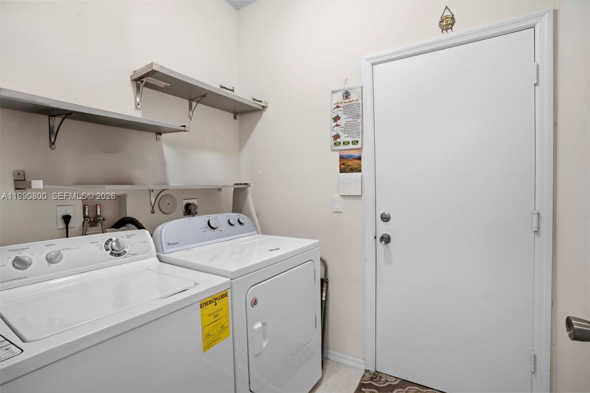 337 Southwest Maclay Way Port St. Lucie, FL 34986 - Photo 31 of 44 a utility room with dryer and washer